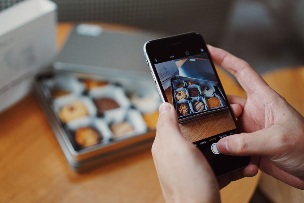 a social media manager taking photos of their brownie product