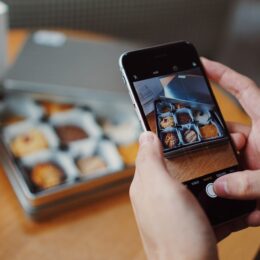 a social media manager taking photos of their brownie product