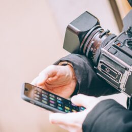 a social media content creator on their phone during a video shoot break