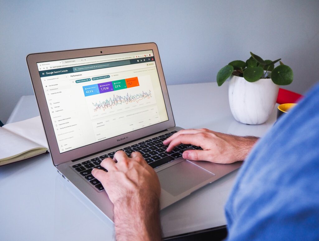 a digital marketer checking the organic SEO stats of his website on a macbook air